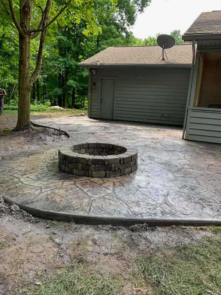 stamped patio with a round fireplace