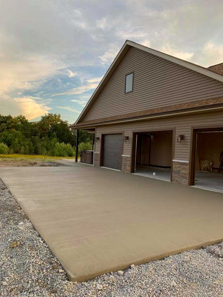 a new concrete driveway of a three-door garage