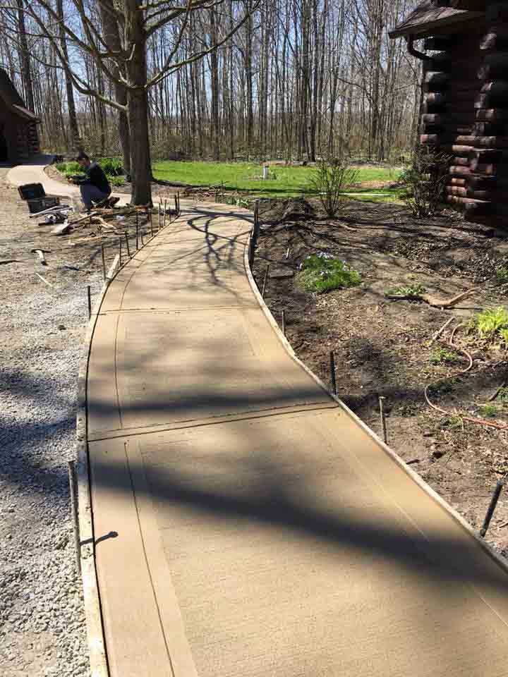 color concrete sidewalk going to the cabin