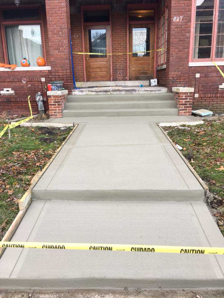 concrete steps replacement and walkway in front of a house