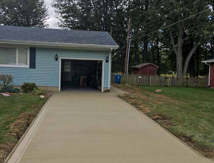 newly replaced concrete driveway of a house garage