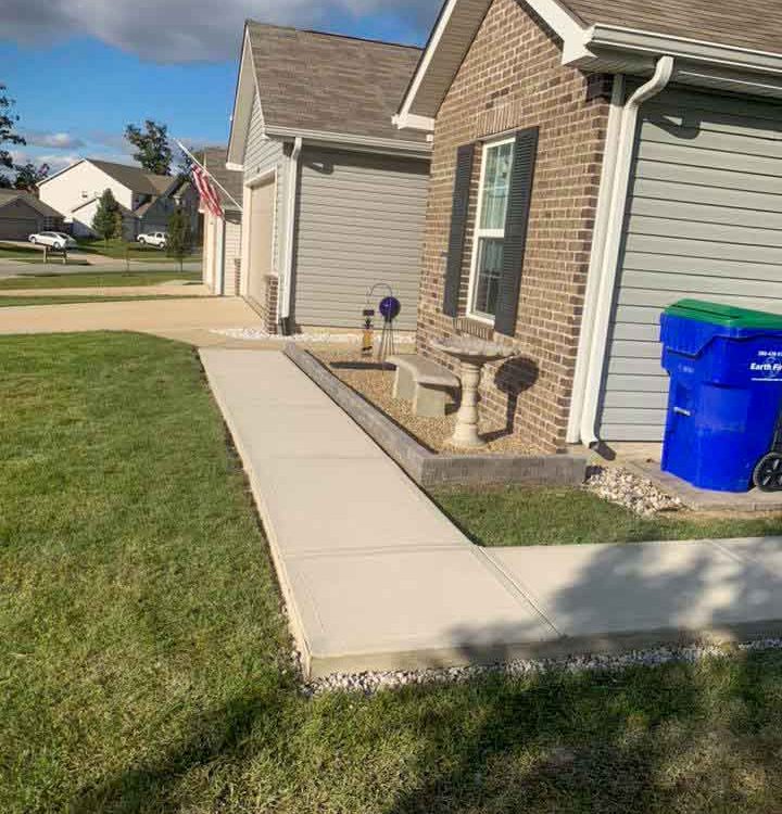 additional sidewalk at the side of a house with an American flag